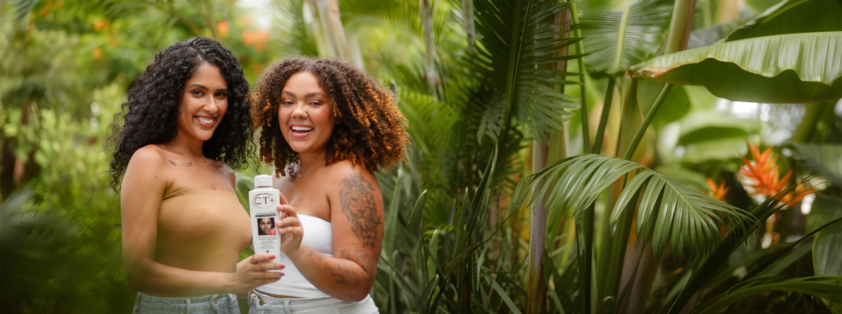 Two women with radiant skin dressed in white holding ct+ lotion and looking at the camera with a cheerful expression.