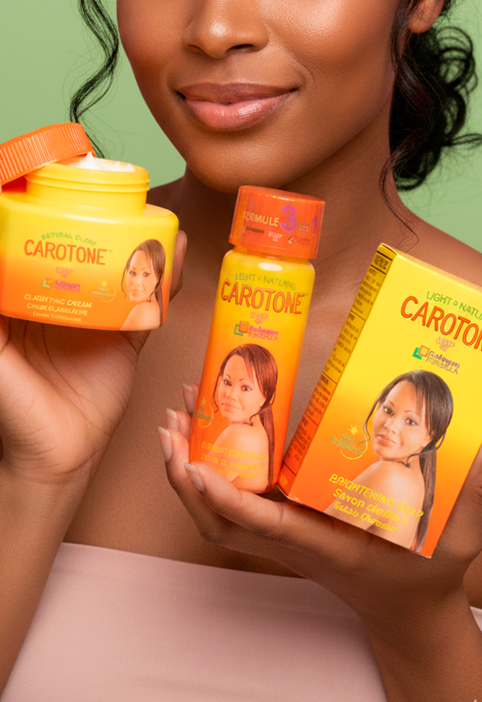 woman holding soap, cream and carotone oil